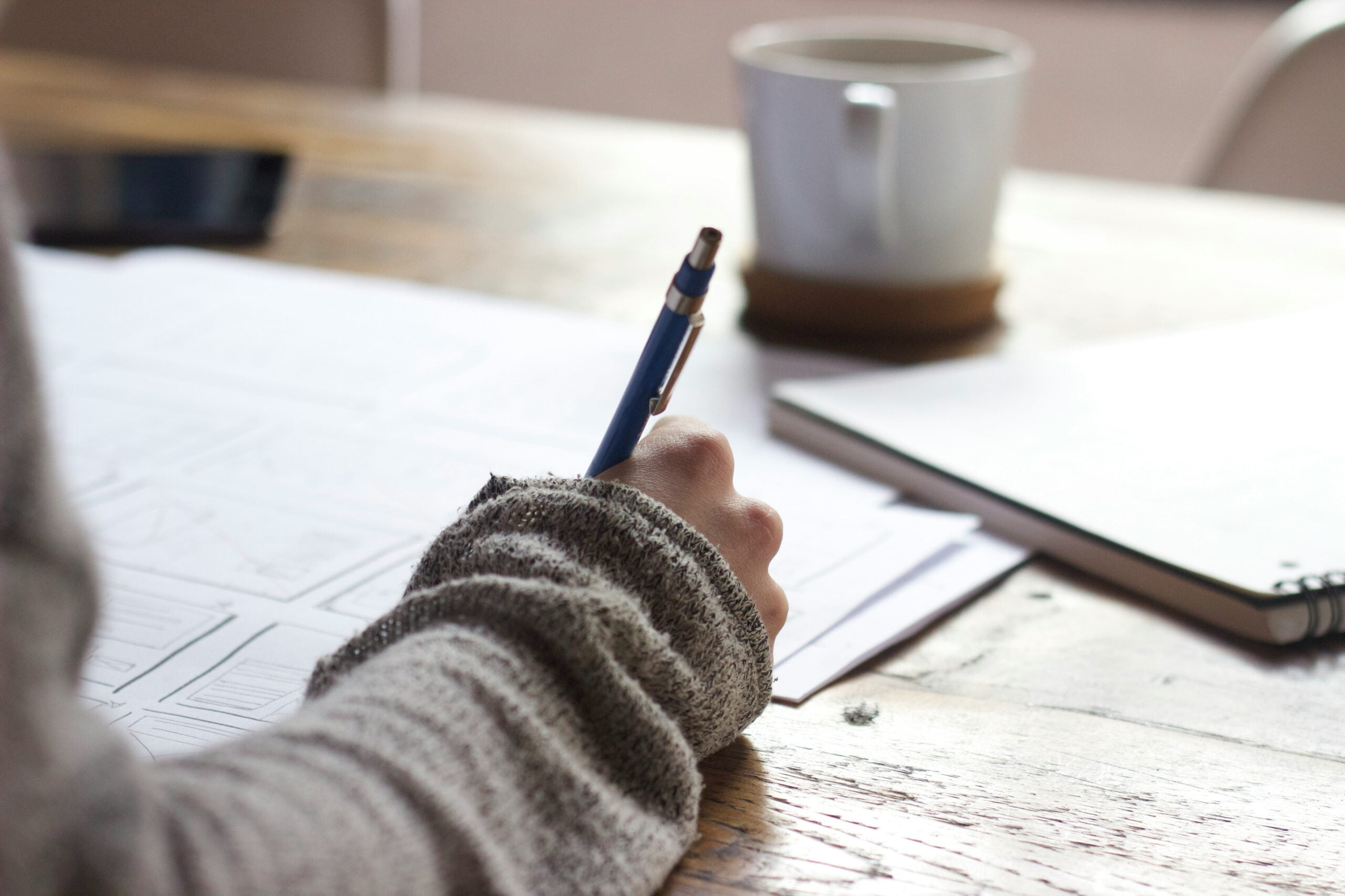 How to Type a Cover Letter - This is What You Need To Secure a Job 2 person writing on brown wooden table near white ceramic mug