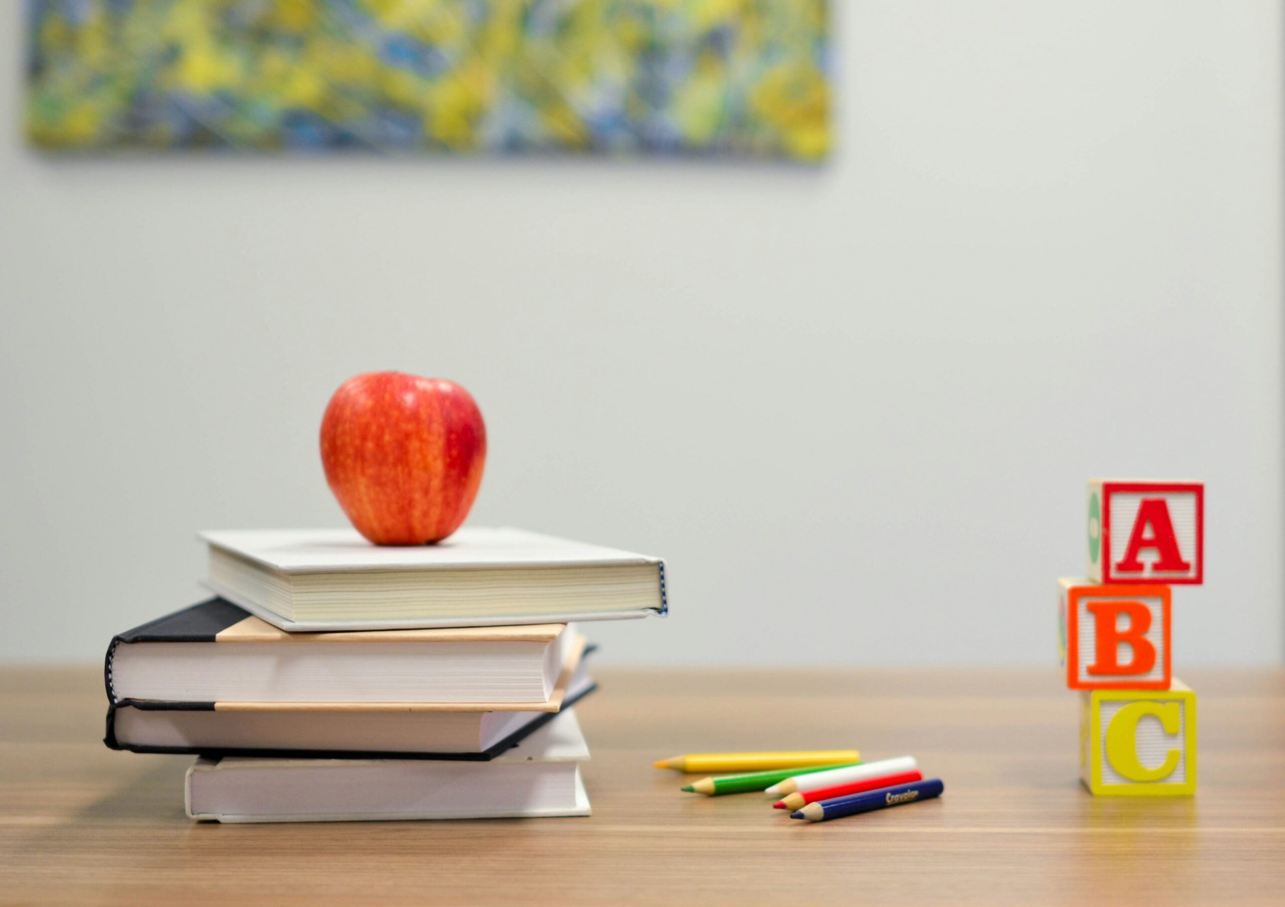 A Comprehensive Guide on How to Become an English Teacher 7 red apple fruit on four pyle books