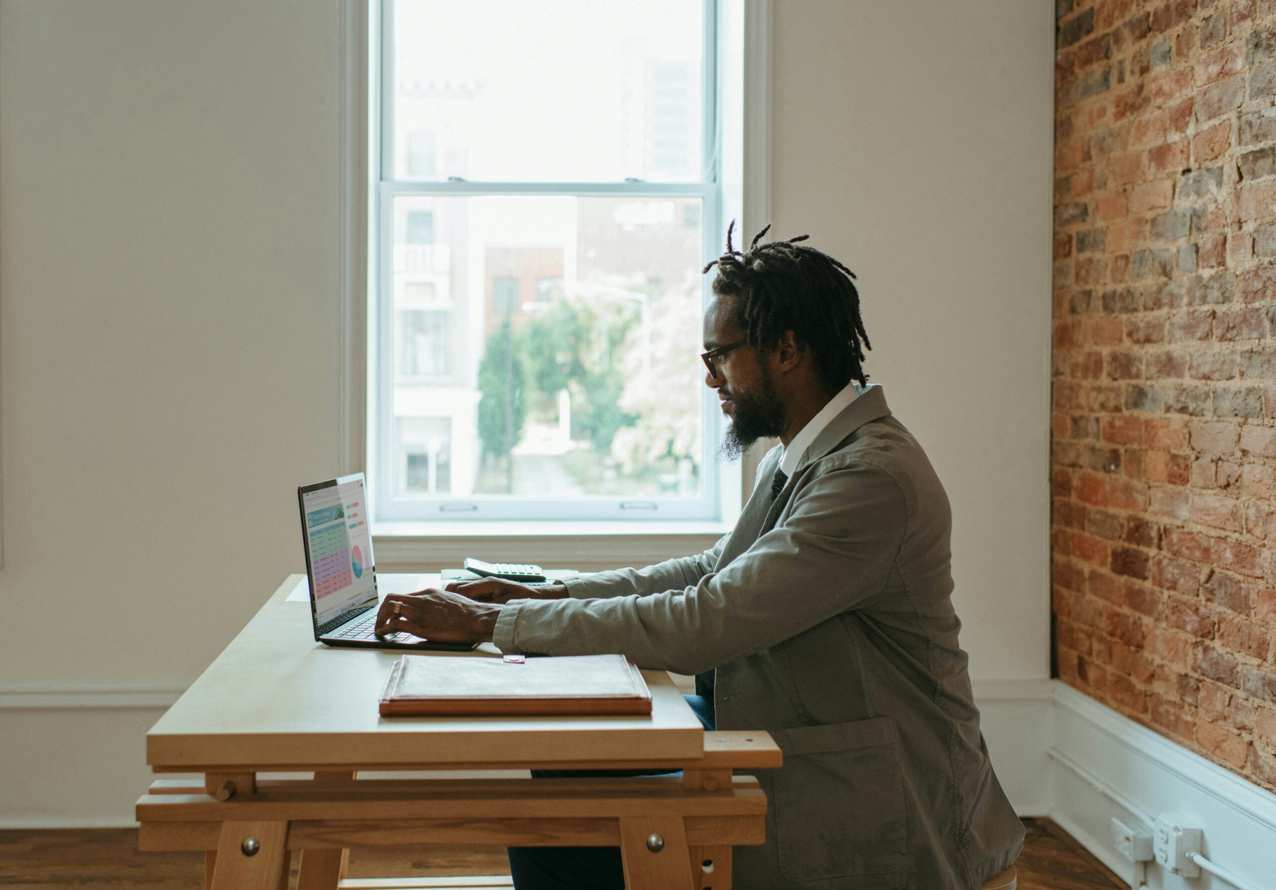 10 Exciting and Enjoyable Remote Jobs: Find Your Perfect Work-from-Home Career 2 a person sitting at a desk with a laptop and papers